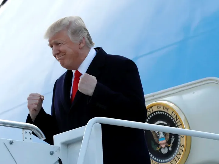 File photo of Donald Trump pumping his fists on the steps of Air Force One.