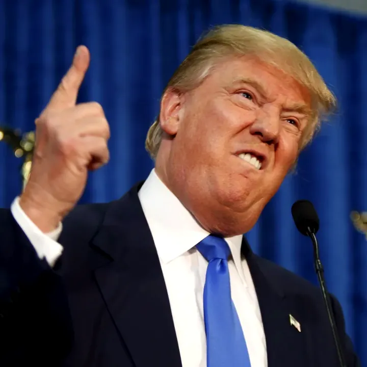 File photo of Donald Trump pointing upward at a podium.